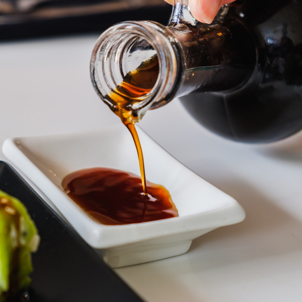 Soy sauce being poured into a small dish