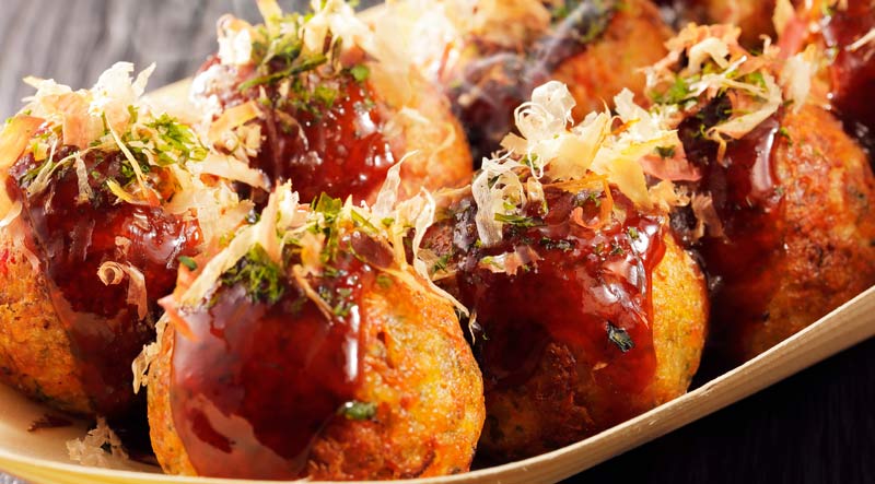 Takoyaki sprinkled with bonito flakes and aonori seaweed