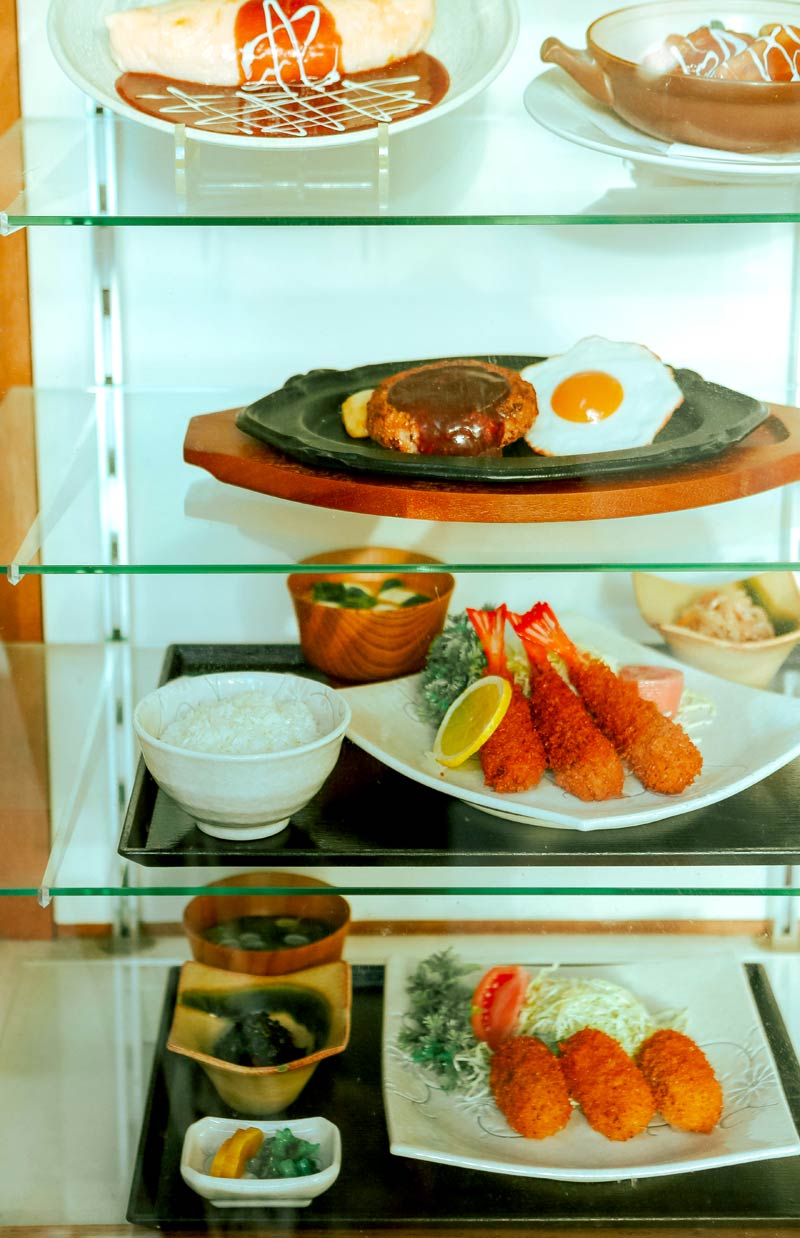 Japanese replica food in a restaurant window - Photo by HANVIN CHEONG on Unsplash