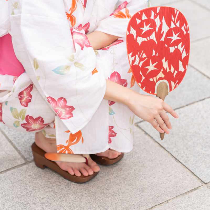 Japanese woman dressed in traditional yukata with fan