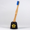 Black ceramic Japanese toothbrush holder with gold samurai crest