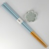Pastel blue chopsticks with matching pale blue flower shaped chopstick rest