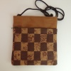 Pochette style handbag in tan and dark brown with a check design