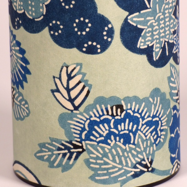 Close up of tall washi paper tea caddy with blue Aomi wave design