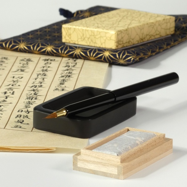 Japanese calligraphy set on desk with handwritten calligraphy