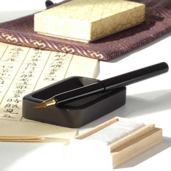 Japanese calligraphy set on desk with handwritten calligraphy