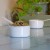 Two white enamel measuring cups in kitchen