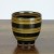Black Japanese tea cup with red stripe pattern on dark kitchen surface