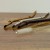 Cleaning brush next to three metal drinking straws