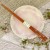Mid tone natural wood Japanese chopsticks on Sakura plate