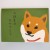 Shiba inu dog character and Japanese birthday greeting on the front of the card