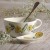 Yellow aster floral design soup cup and spoon rest on table