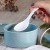 White enamel soup spoon in blue futamono bowl