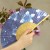 Blue hydrangea design Japanese fan held in hand