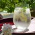 Japanese glass tumbler with mimosa and gypsophila floral design on a pretty outdoor table