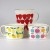 Three colourful fruit themed Japanese enamel measuring jugs