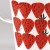 Close up of bold red strawberry design on enamel jug