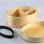 Inside of light wood bento box with food divider and elastic strap