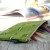 Green zip up matcha cake design pencil case on a sunny desk