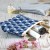 Small Fujiyama zip pouch on table top holding coins and cosmetic items
