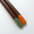 Colourful chopstick ends with retro design in orange and turquoise