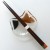 Dark wood Japanese chopstick with retro design on glass cat shaped dish
