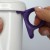 Hand showing how to attach purple mug handle