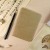 Ro-biki 'Fushi-iro' Texture Series Japanese notebook on desk with brush pen and calligraphy