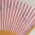 Close up of pale pink sakura cherry blossom design on Japanese fan