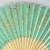 Close up of pale green and gold fireworks design on Japanese fan
