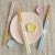 Pastel chopstick and chopstick rest sets in pastel pink, yellow and blue on a table with pale pink plate