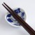 Close up of calico cat chopstick rest with chopsticks