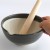 Extra large Japanese black suribachi held in a hand